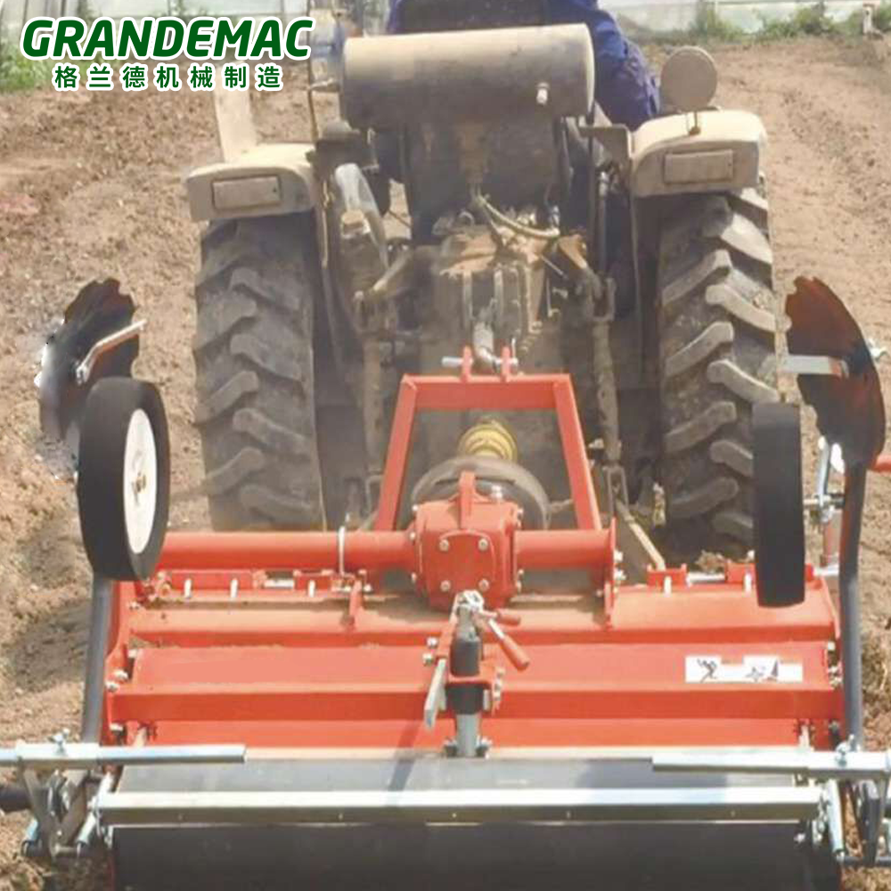 Tractor plastic mulch layer operating in a field